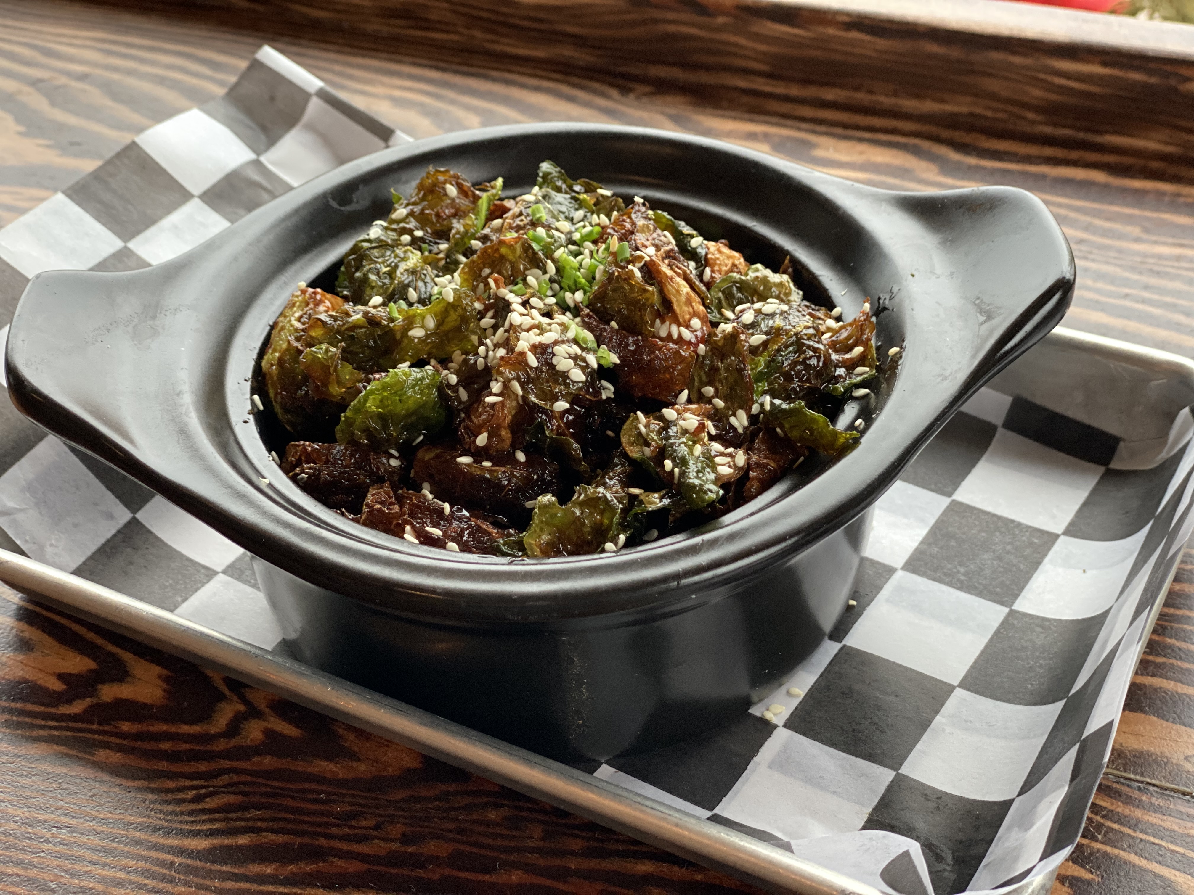 Deep fried and tossed in our house Sweet Chili Soy Sauce and sprinkled with toasted sesame seeds and scallions