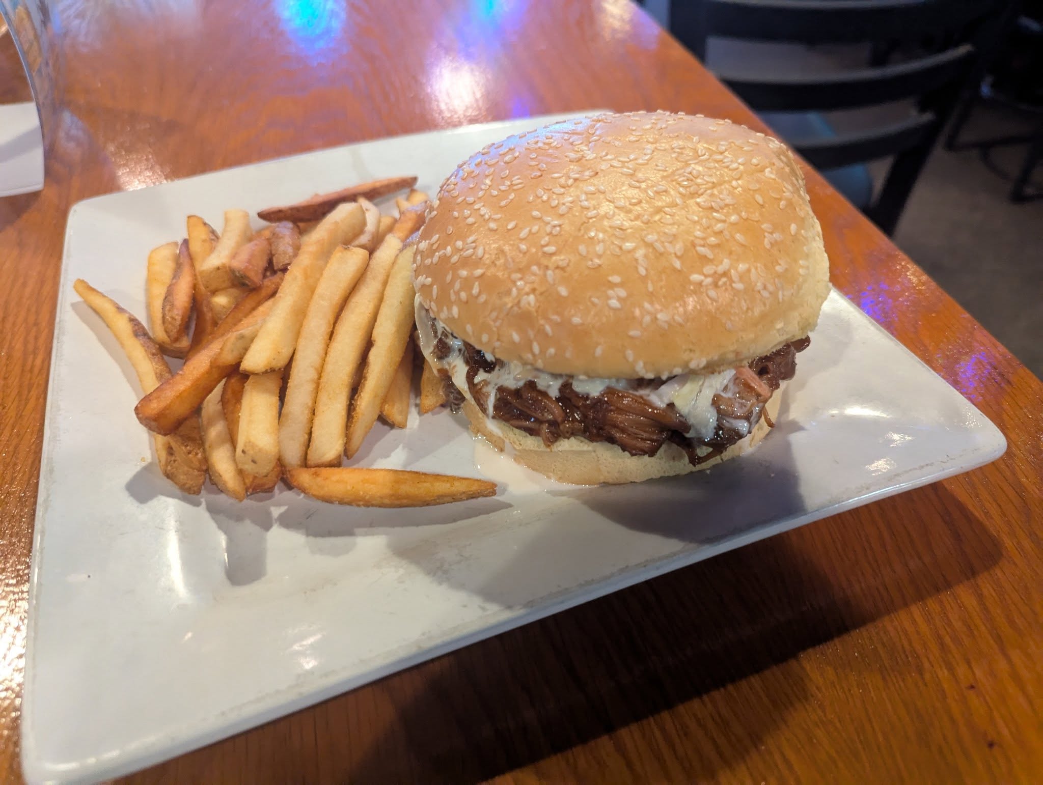 BBQ Pork Burnt Ends topped with homemade Cole Slaw on a fluffy sesame seed bun with your choice of a side.
