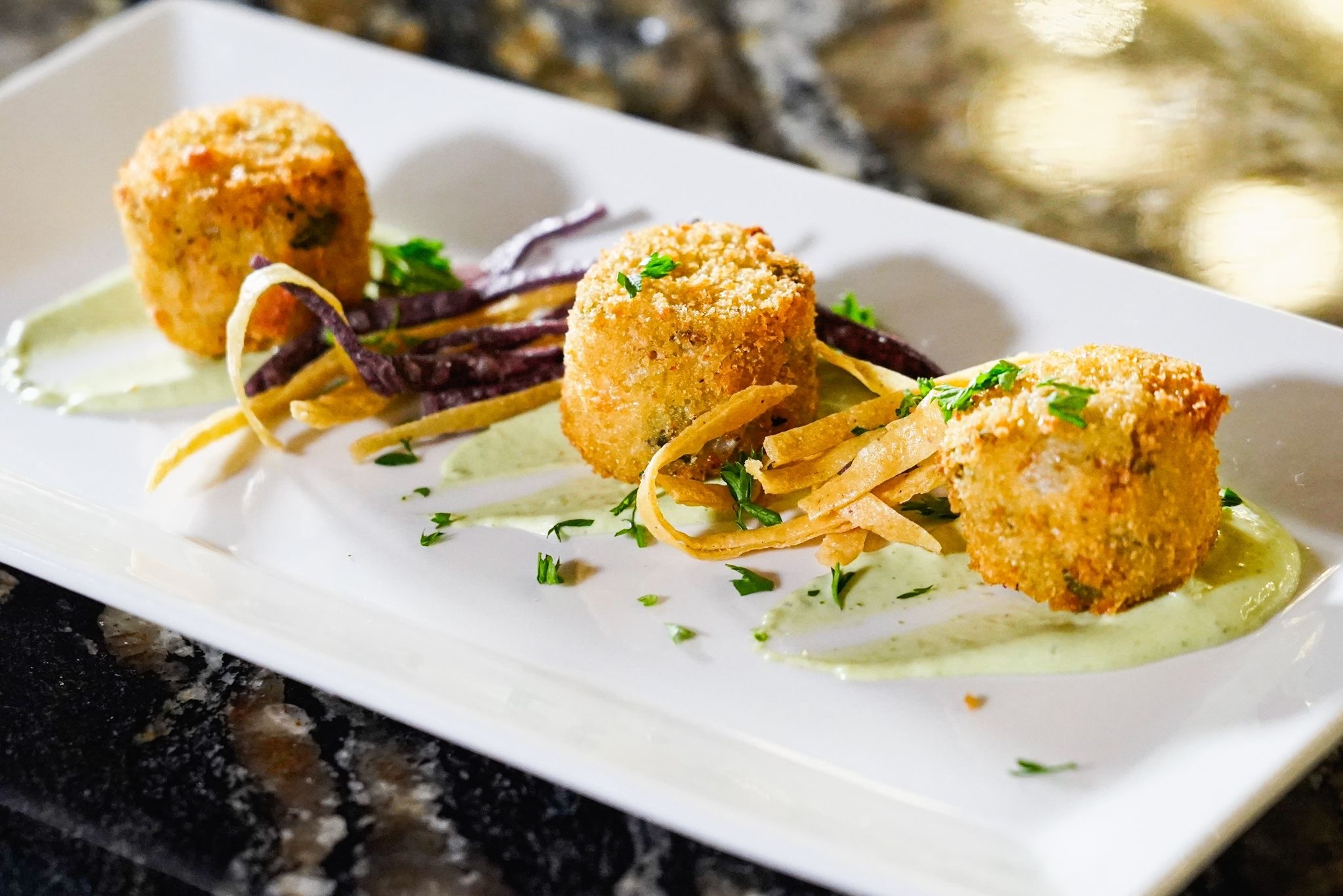 Crab Cakes ⬡ Lump crab meat, chipotle remoulade, tortilla strips.
