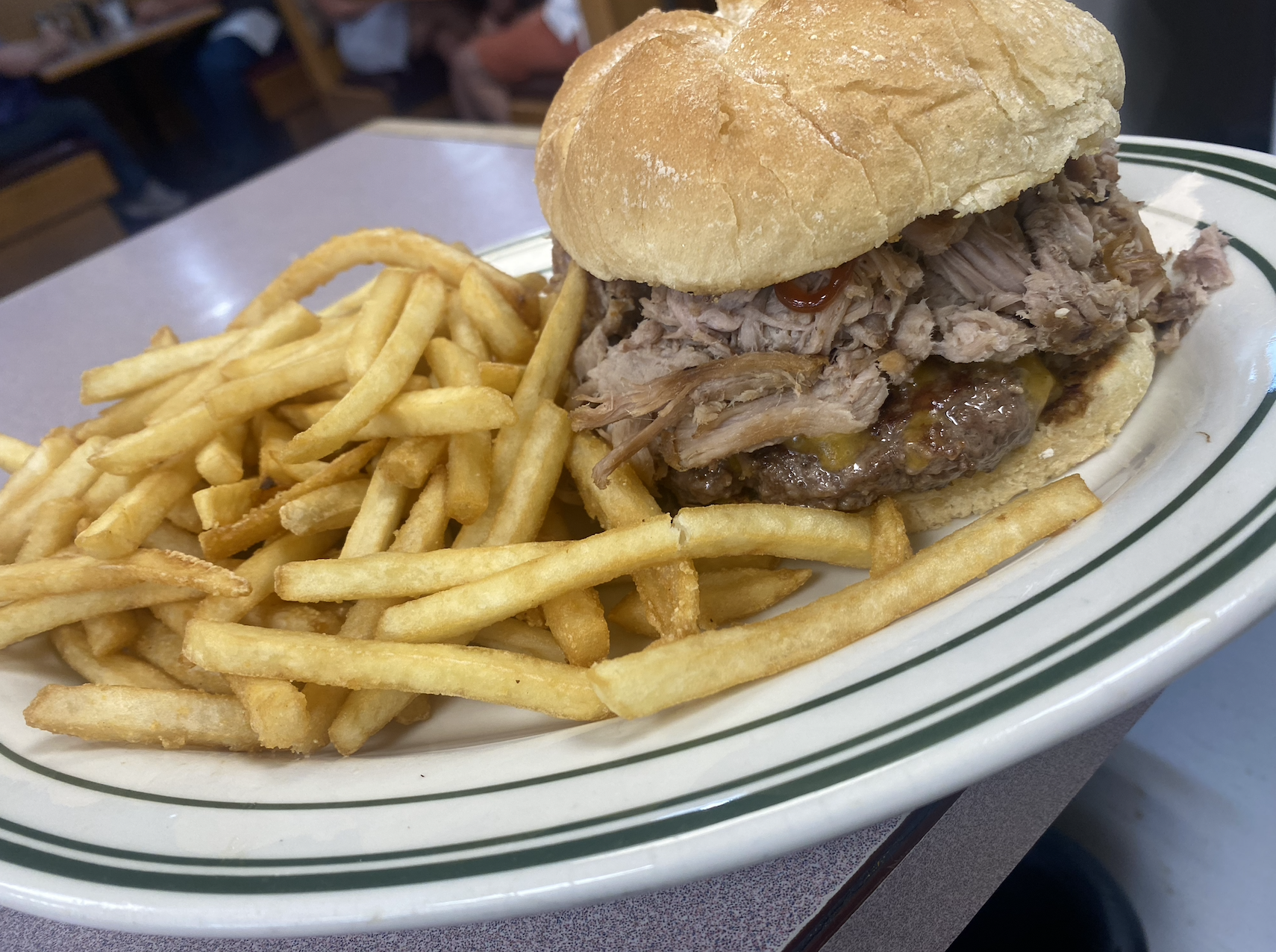 Pulled Pork, BBQ Sauce, Cheddar Cheese on top of  a Burger